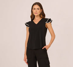 Flutter Sleeve Contrast Tipped Top In Black Ivory